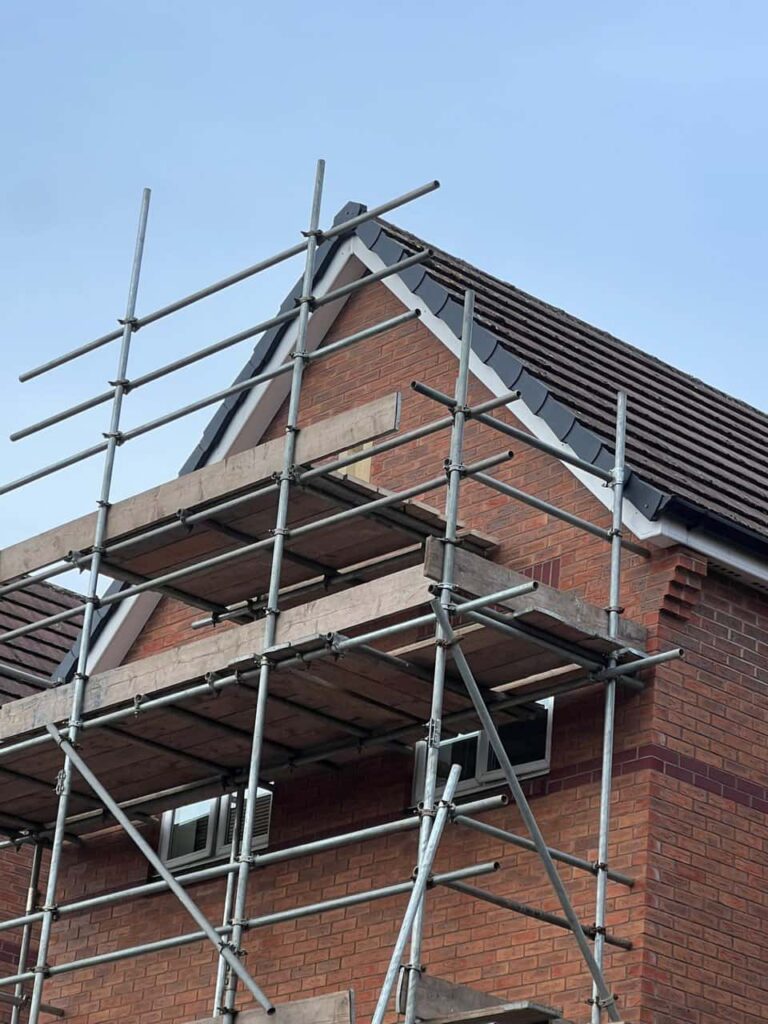 This is a photo of a roof which has just been repaired. There is a scaffold located at the gable end for access onto the roof. Works carried out by LJ Roofing Penhill